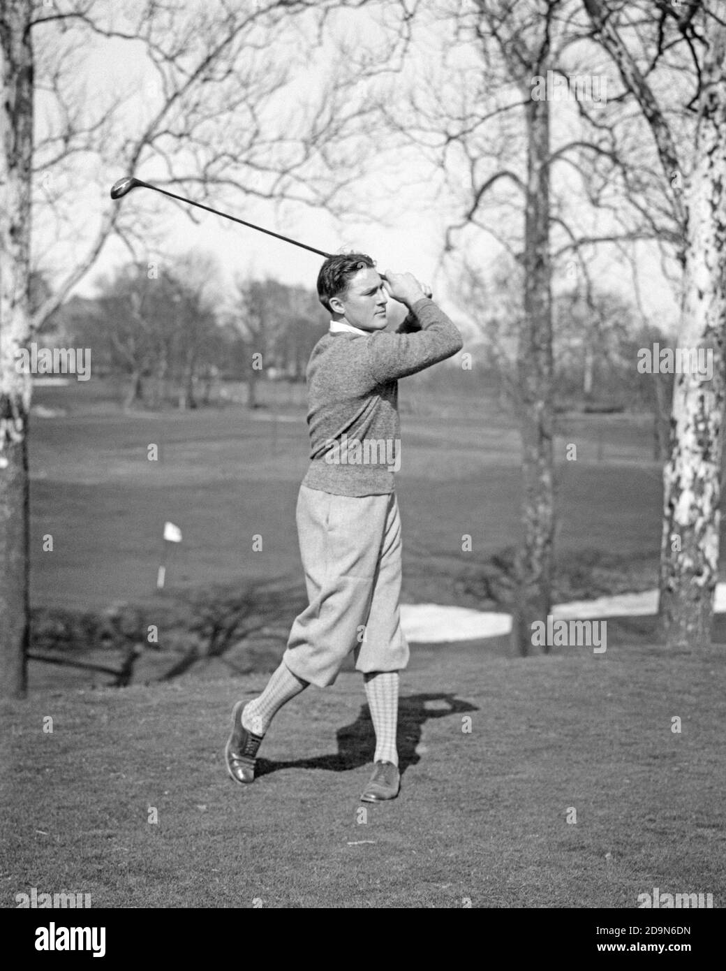 1930s SPORTS MAN GOLFER WEARING SWEATER AND PLUS FOURS BREECHES STRIKING HITTING GOLF BALL WITH WOODEN DRIVER CLUB - g1652 HAR001 HARS COPY SPACE FULL-LENGTH PHYSICAL FITNESS PERSONS MALES GOLFING ATHLETIC CONFIDENCE B&W HITTING GOALS SKILL ACTIVITY AMUSEMENT HAPPINESS PHYSICAL WELLNESS GOLFERS HOBBY LEISURE STRENGTH TROUSERS STRATEGY INTEREST AND CHOICE HOBBIES KNOWLEDGE PROGRESS RECREATION PASTIME FAIRWAY PLEASURE CONCEPTUAL ESCAPE FLEXIBILITY LINKS MUSCLES STYLISH PLUS FOURS GROWTH MID-ADULT MID-ADULT MAN PRECISION RELAXATION STRIKING AMATEUR BLACK AND WHITE BREECHES CAUCASIAN ETHNICITY Stock Photo