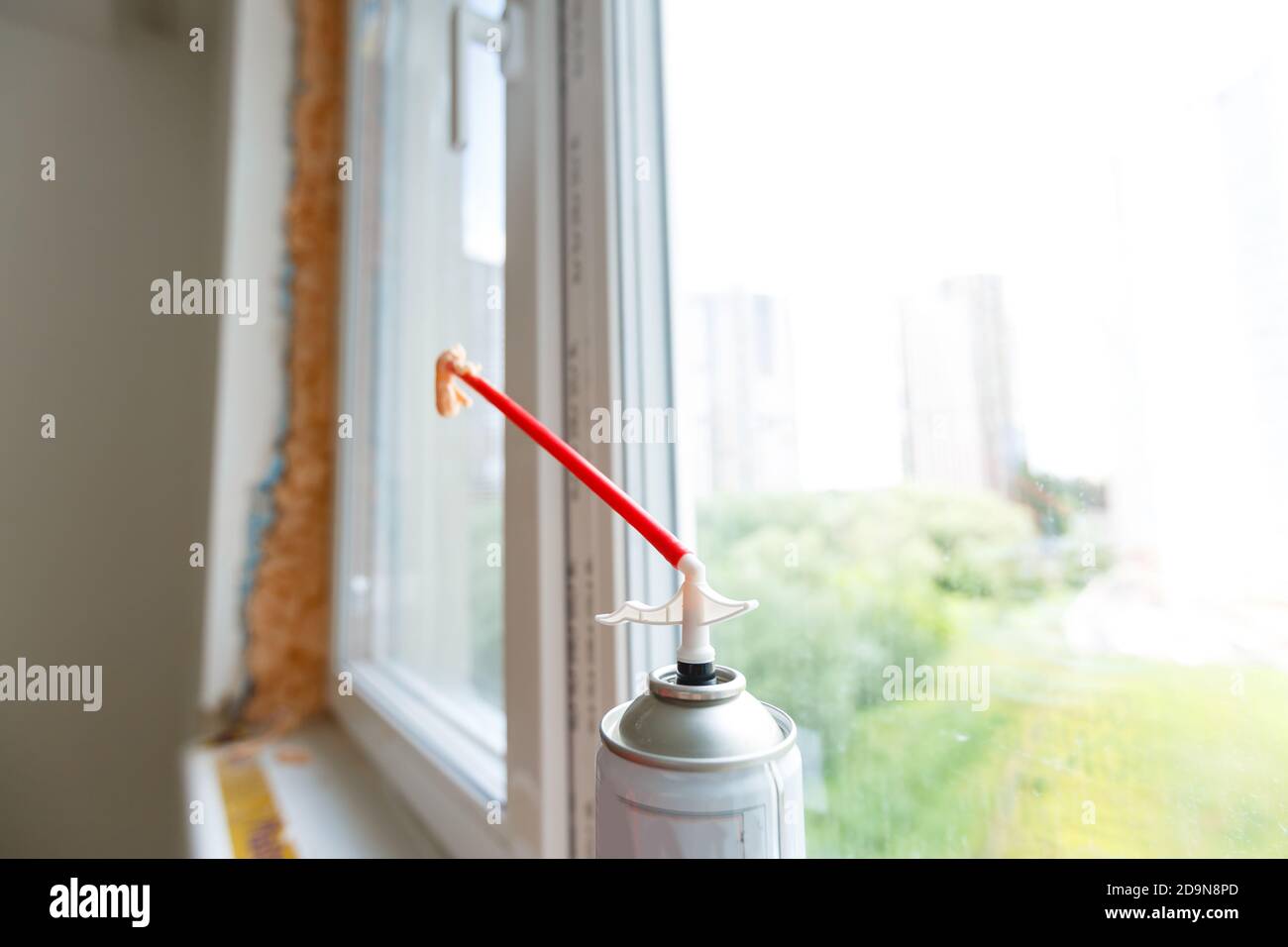 Process installation slopes of window. Using a moanting foam. Stock Photo