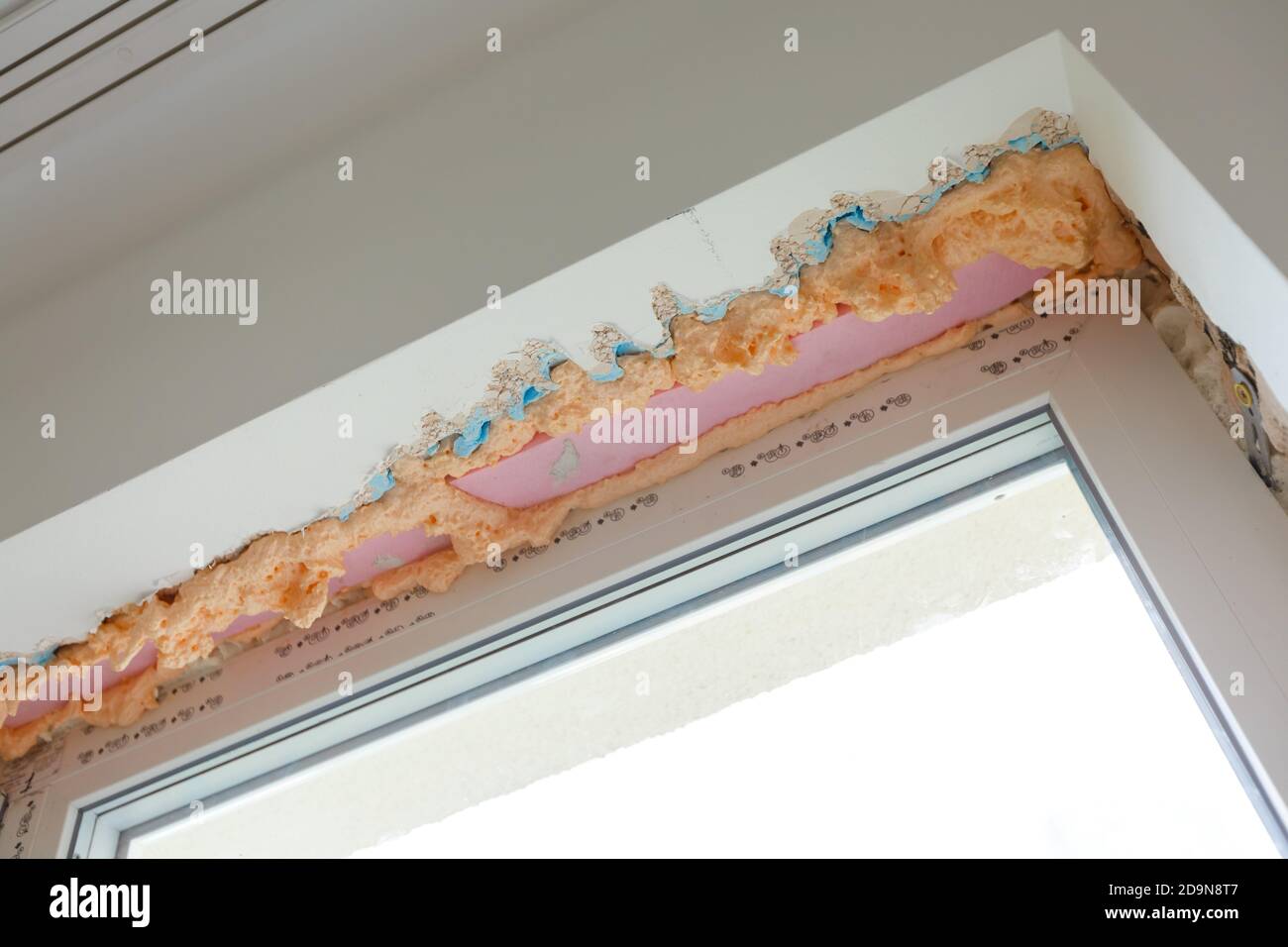 Process installation slopes of window. Using a moanting foam. Stock Photo