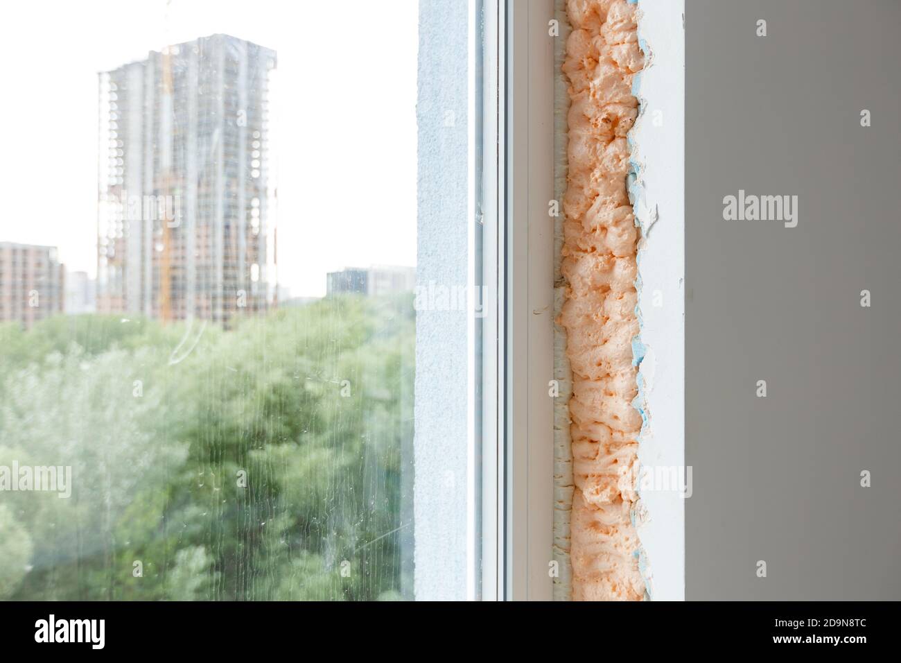 Process installation slopes of window. Using a moanting foam. Stock Photo
