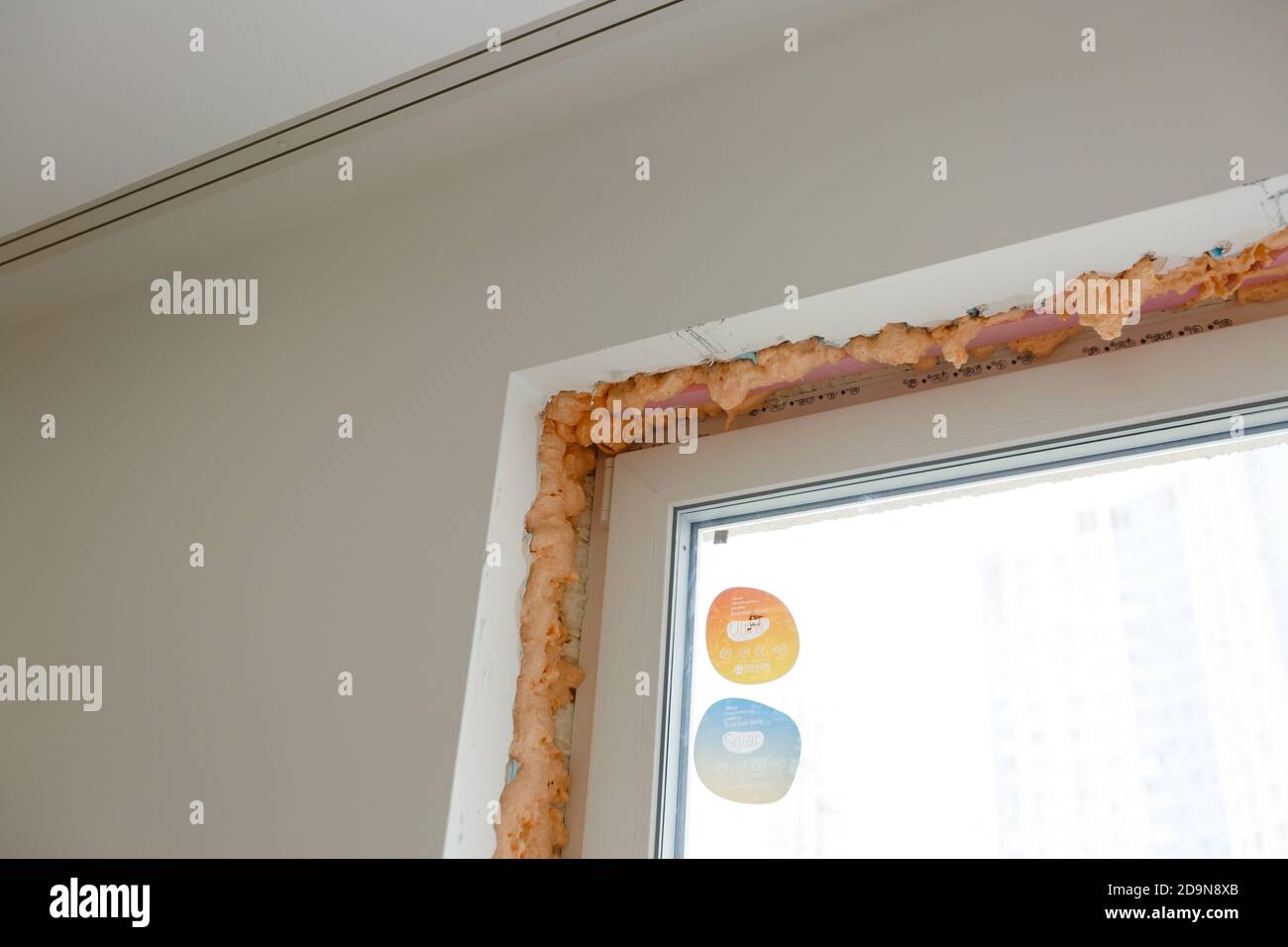 Process installation slopes of window. Using a moanting foam. Stock Photo