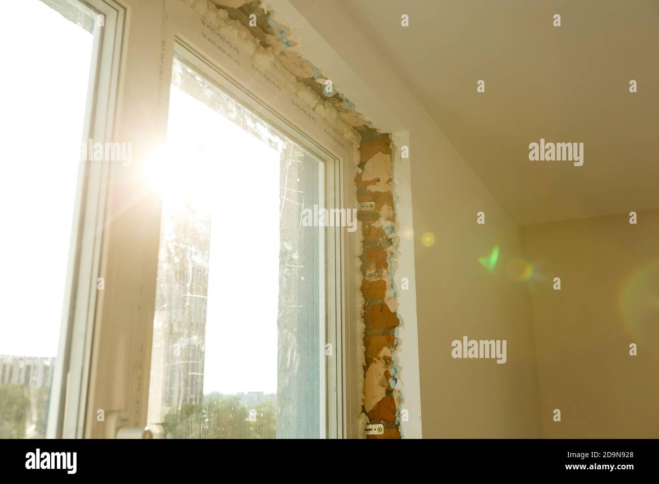 Process installation slopes of window. Using a moanting foam. Stock Photo