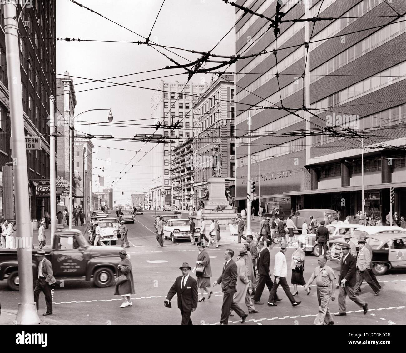 1960s CITYSCAPE MARIETTA AND FORSYTHIA STREETS OVERHEAD WIRES POWERING TRACKLESS TROLLEY ELECTRIC BUS SYSTEM ATLANTA GEORGIA USA - r10773 HAR001 HARS FORSYTHIA BLACK AND WHITE CITYSCAPE GA HAR001 OLD FASHIONED Stock Photo