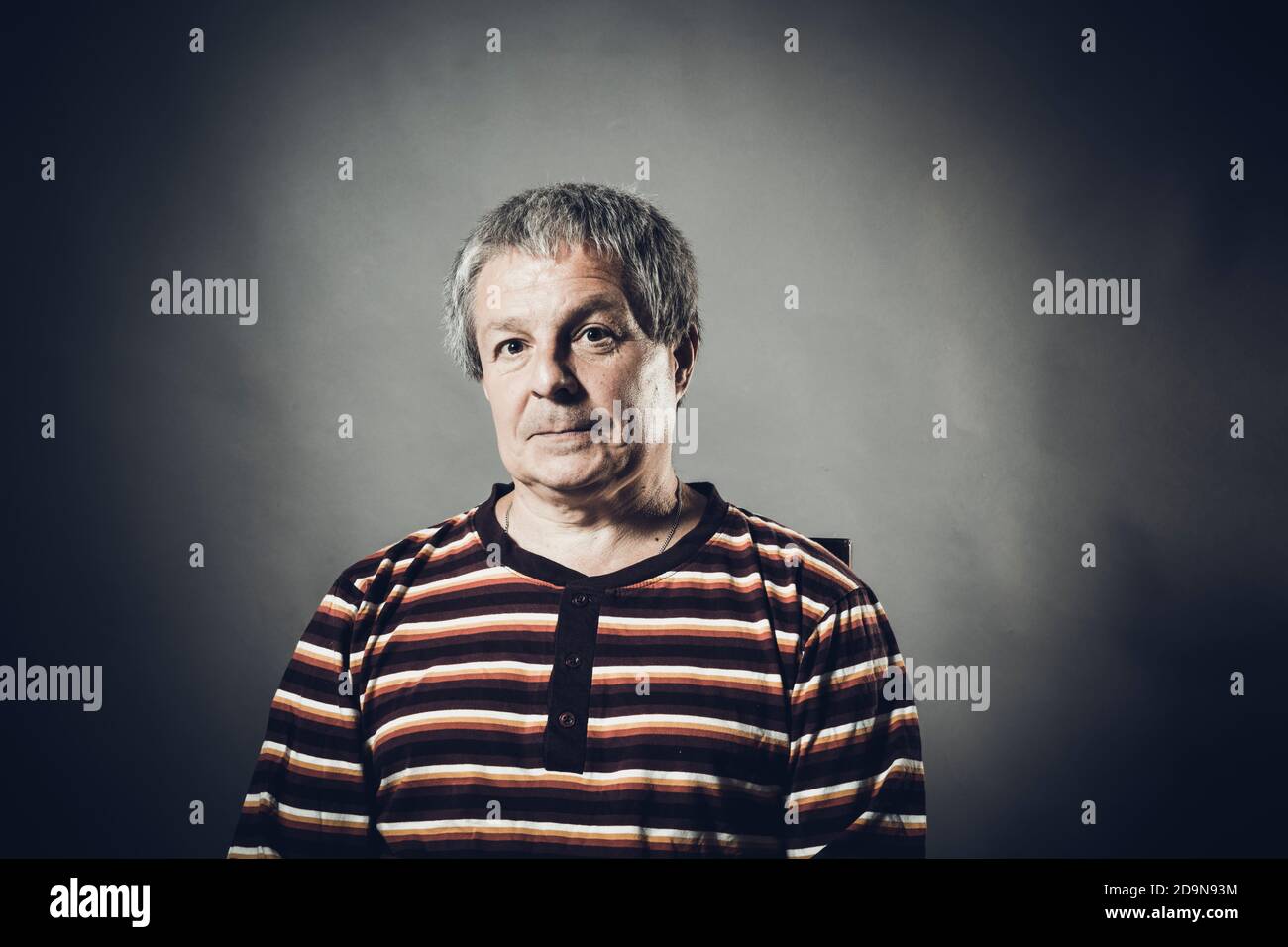 Solid middle aged man studio portrait on grey background Stock Photo