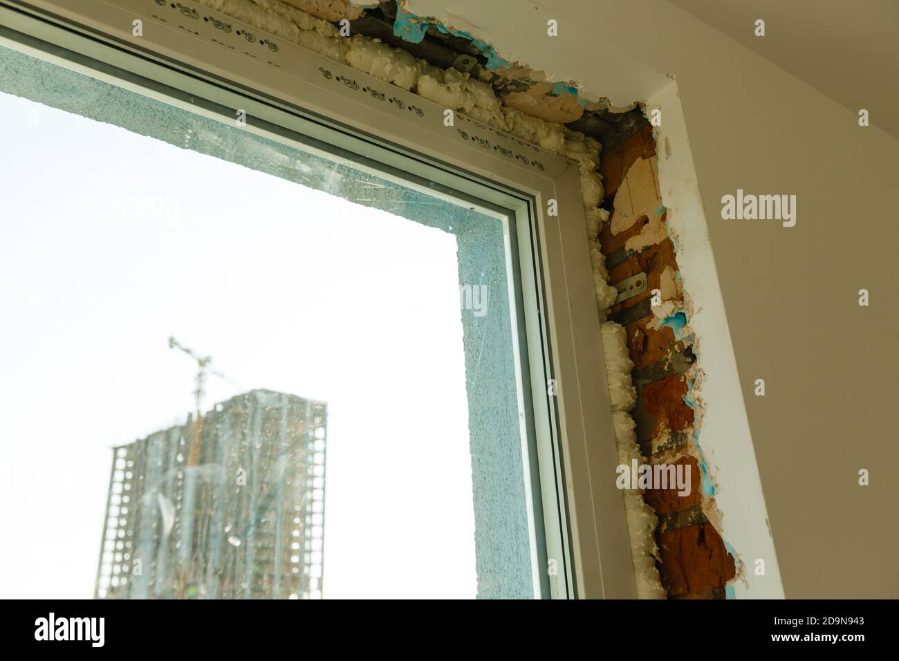 Process installation slopes of window. Using a moanting foam. Stock Photo