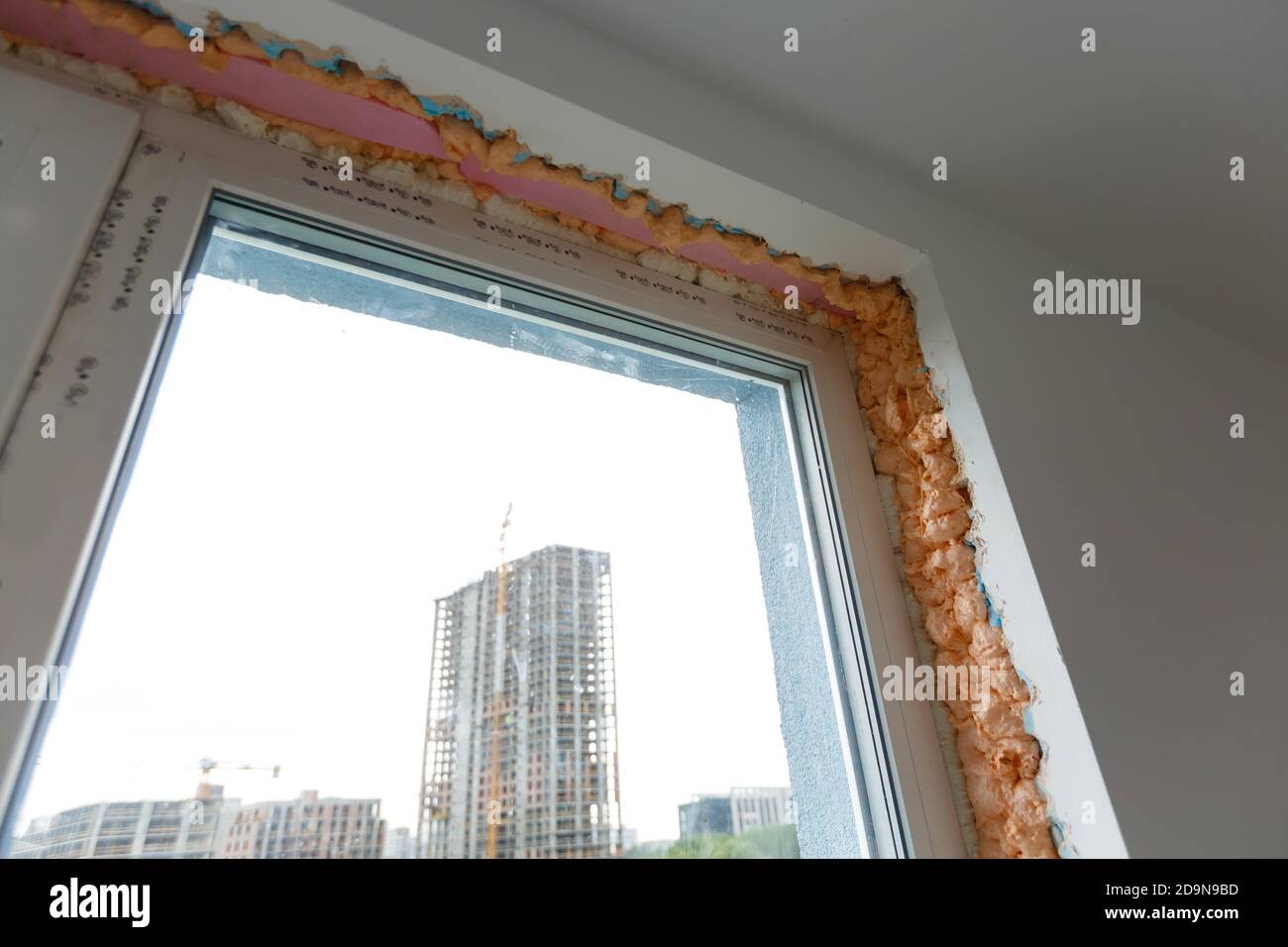Process installation slopes of window. Using a moanting foam. Stock Photo