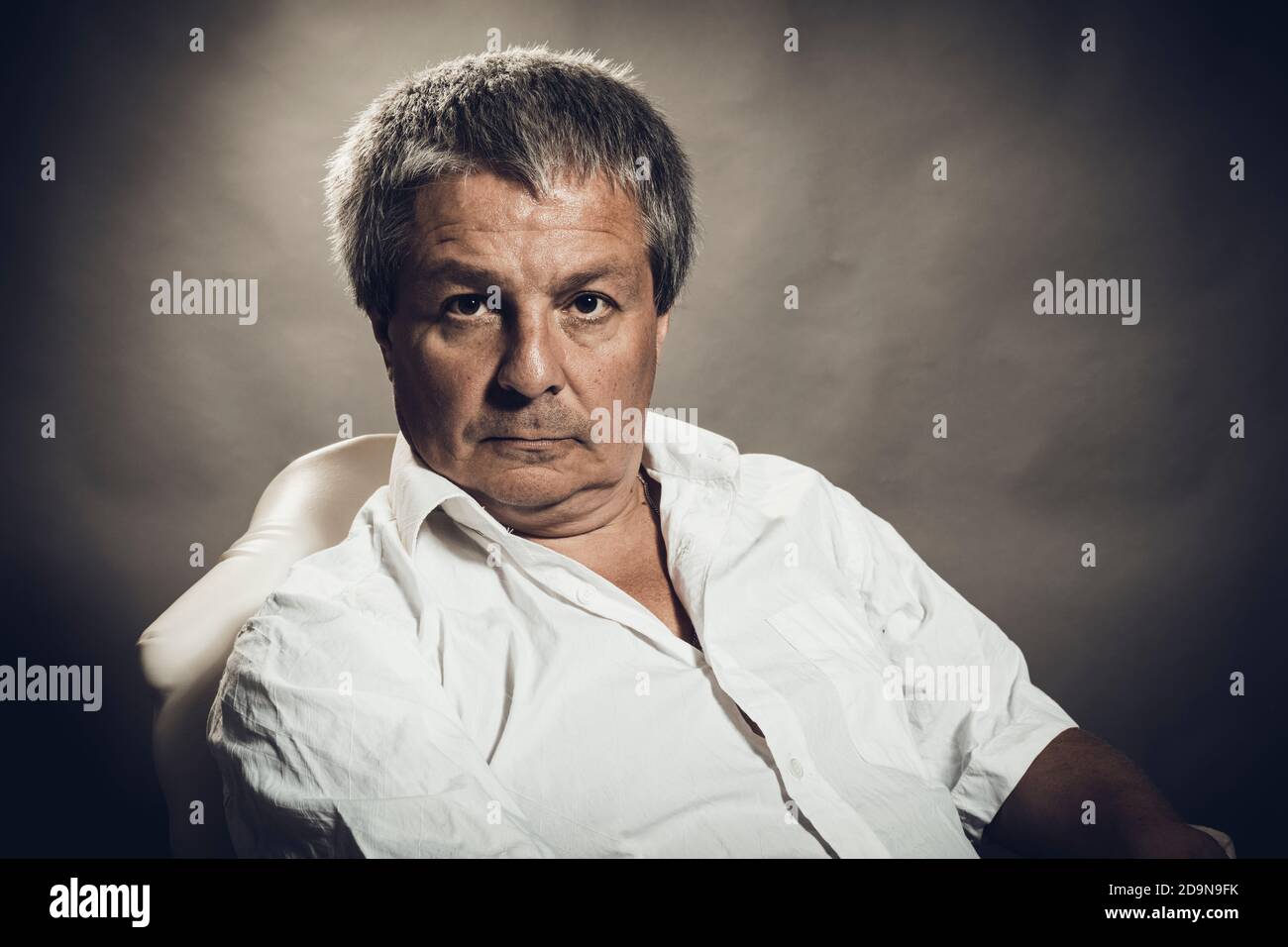 Solid middle aged man studio portrait on grey background Stock Photo