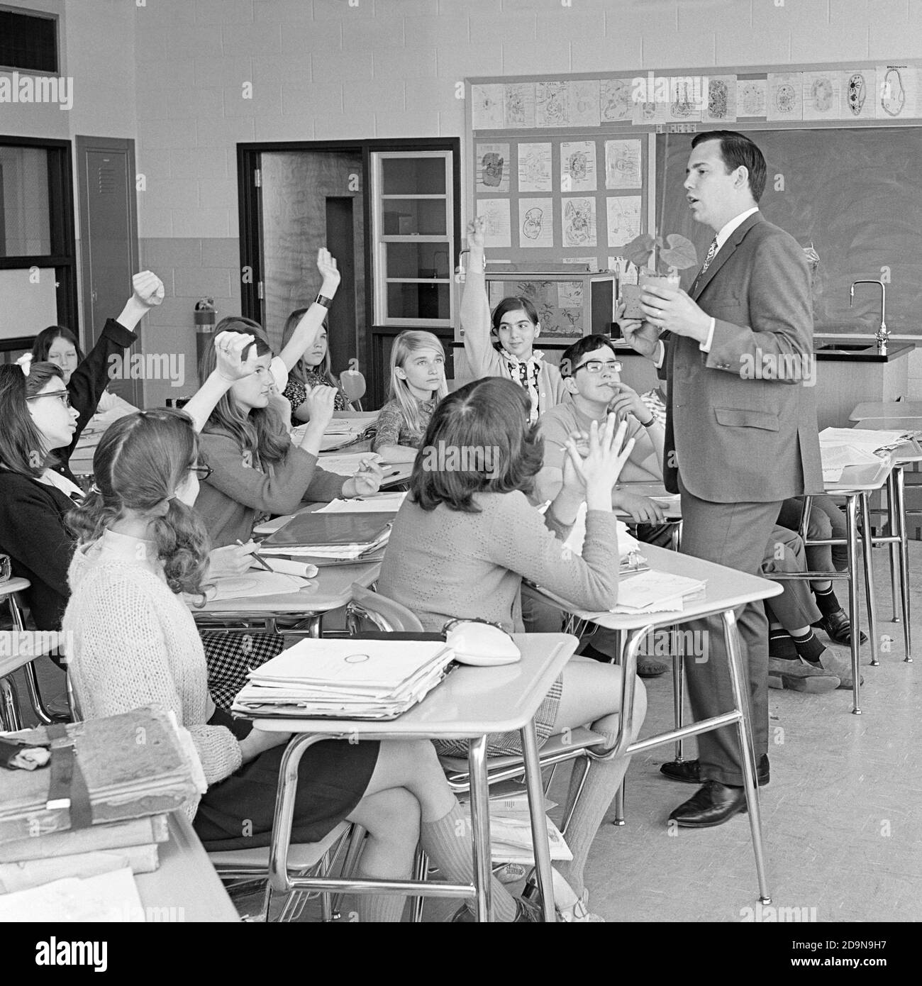 1960s MAN TEACHER ASKING CLASS A QUESTION FOUR STUDENTS RAISING HANDS TO ANSWER - s17971 KRU001 HARS LIFESTYLE SATISFACTION FEMALES COPY SPACE FULL-LENGTH ASKING PERSONS INSPIRATION MALES TEENAGE GIRL TEENAGE BOY RAISING B&W DESKS GOALS SCHOOLS DISCOVERY STRATEGY INSTRUCTOR KNOWLEDGE QUESTION HIGH SCHOOL OCCUPATIONS HIGH SCHOOLS CONNECTION ANSWER EDUCATOR TEENAGED COOPERATION EDUCATING EDUCATORS GROWTH INSTRUCTORS JUVENILES MID-ADULT MAN MIDDLE SCHOOL SCHOOL TEACHES BLACK AND WHITE CAUCASIAN ETHNICITY OLD FASHIONED Stock Photo