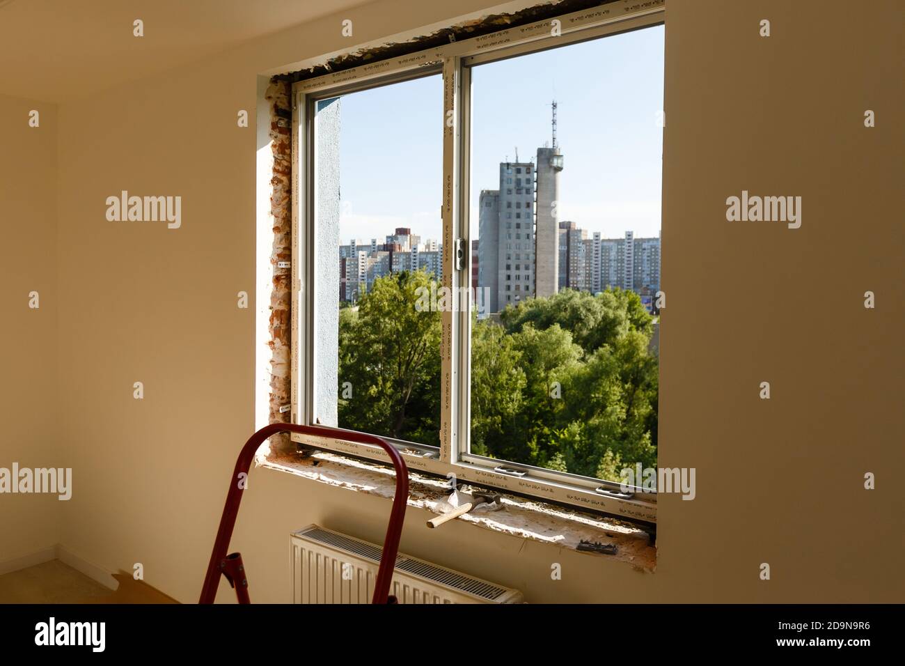 Process installation slopes of window. Using a moanting foam. Stock Photo
