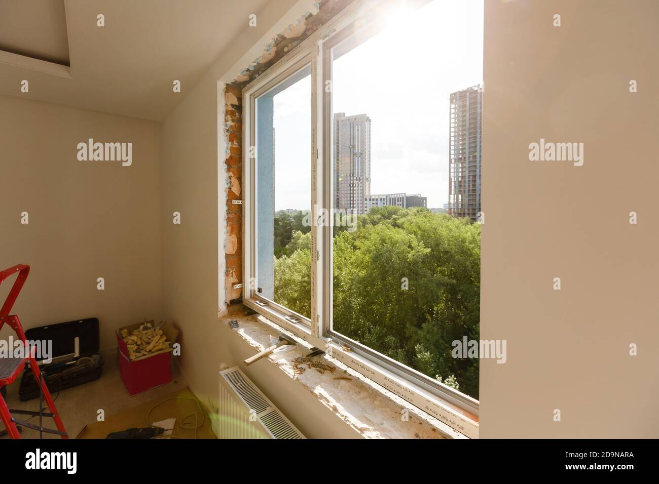 Process installation slopes of window. Using a moanting foam. Stock Photo