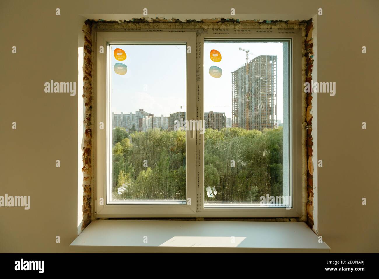 Process installation slopes of window. Using a moanting foam. Stock Photo