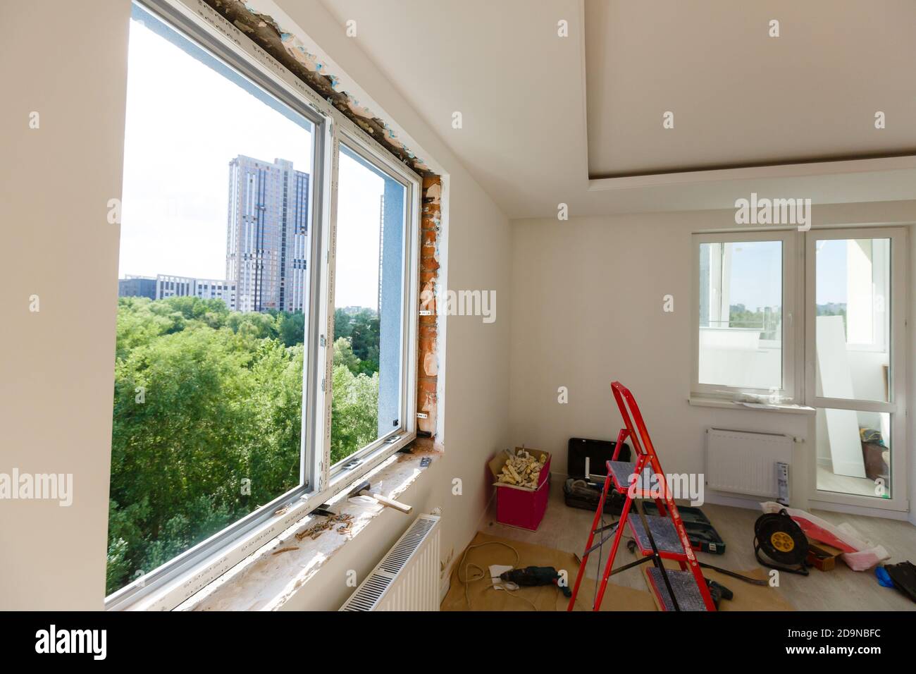 Process installation slopes of window. Using a moanting foam. Stock Photo