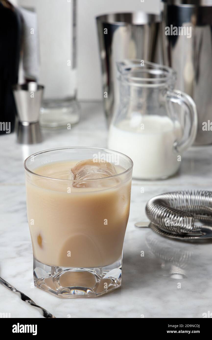 Famous White Russian Cocktail with Vodka, Coffee Liquor and Cream on a marble table Stock Photo