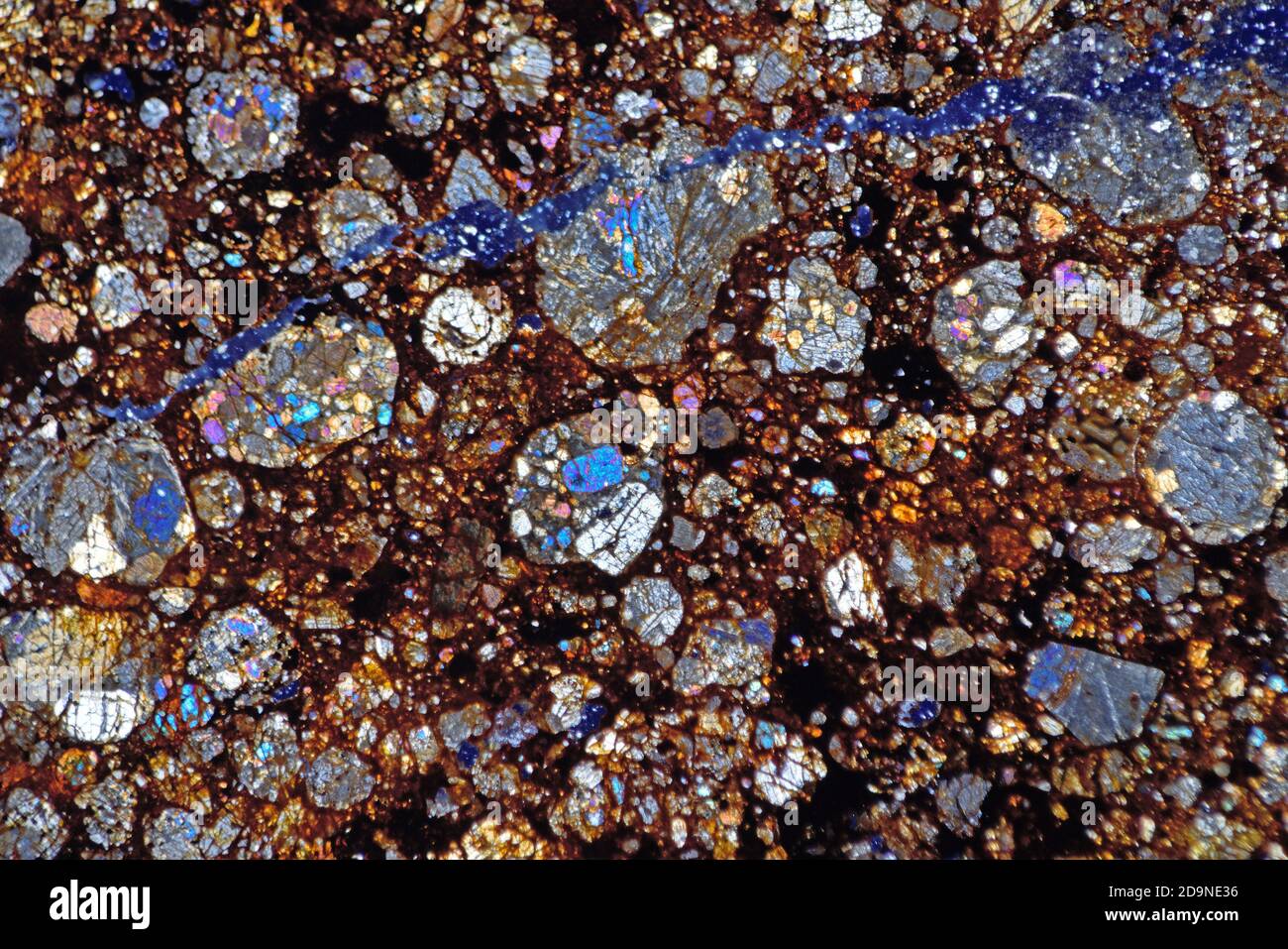 NWA meteorite microscope thin section slide showing chondrules, polarised illumination. Chondrule rich, Sahara desert, Morocco Stock Photo