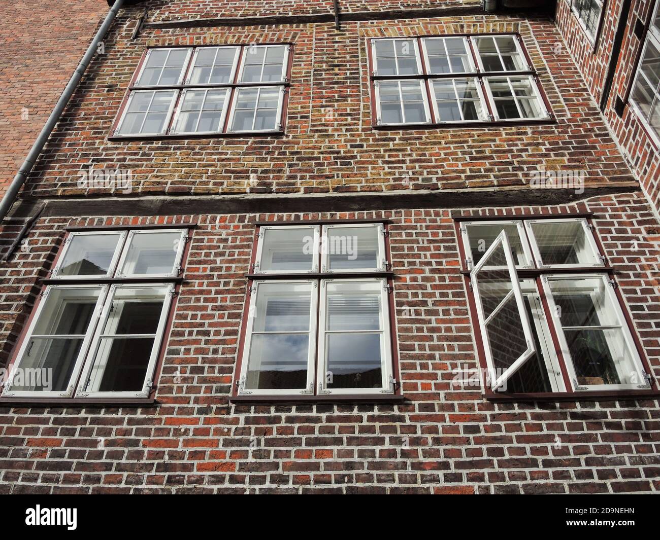 Low angle shot of an old brick house with lattice windows Stock Photo