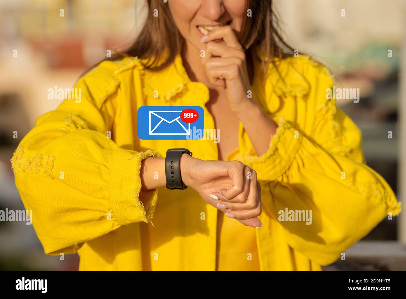 Young woman receiving tons of messages. New email alerts or icons of unread messages on the smart watch. Email overload, spam concept Stock Photo