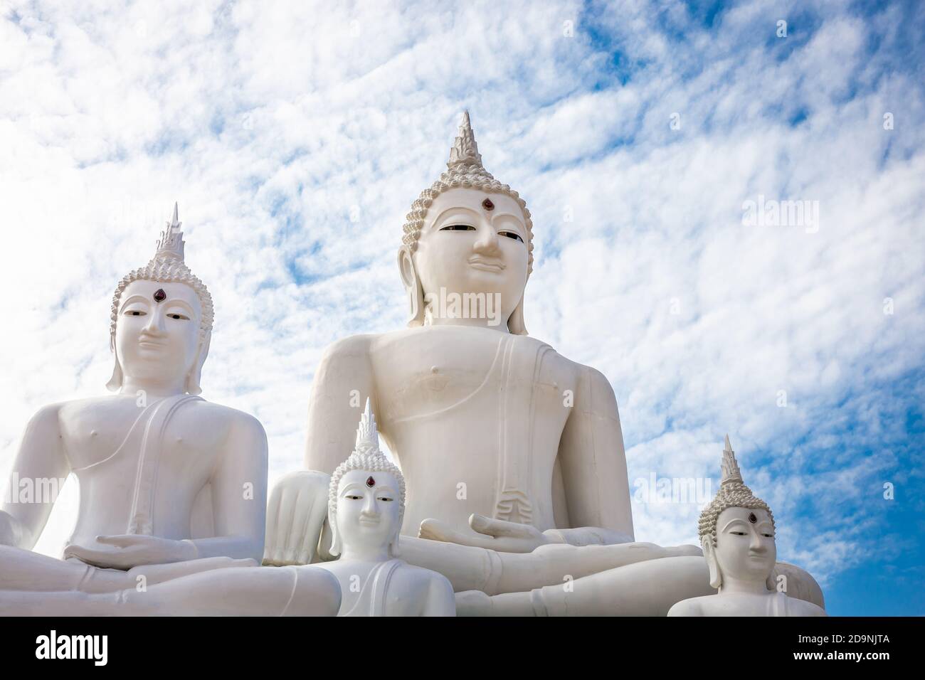 Many white Buddha on blue sky and cloud background Stock Photo