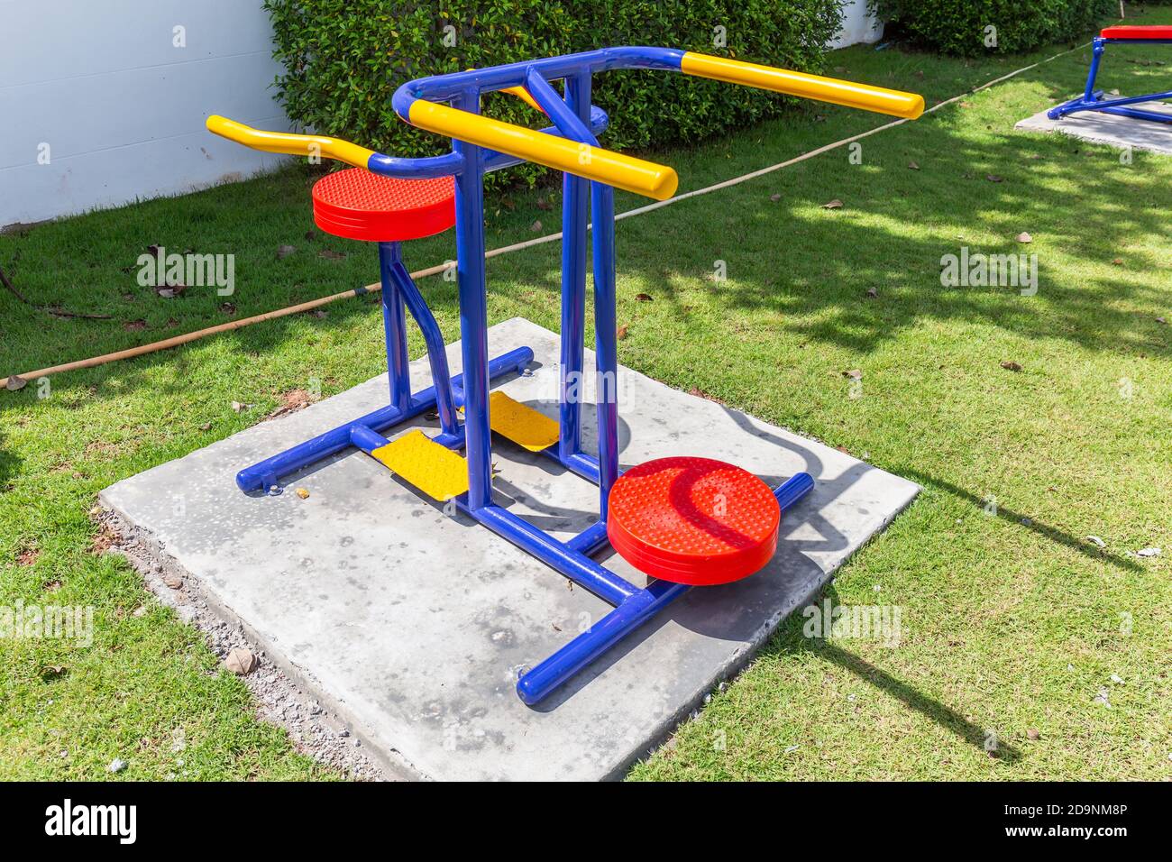Colorful playground equipment and exercise at grass field outdoor public Stock Photo