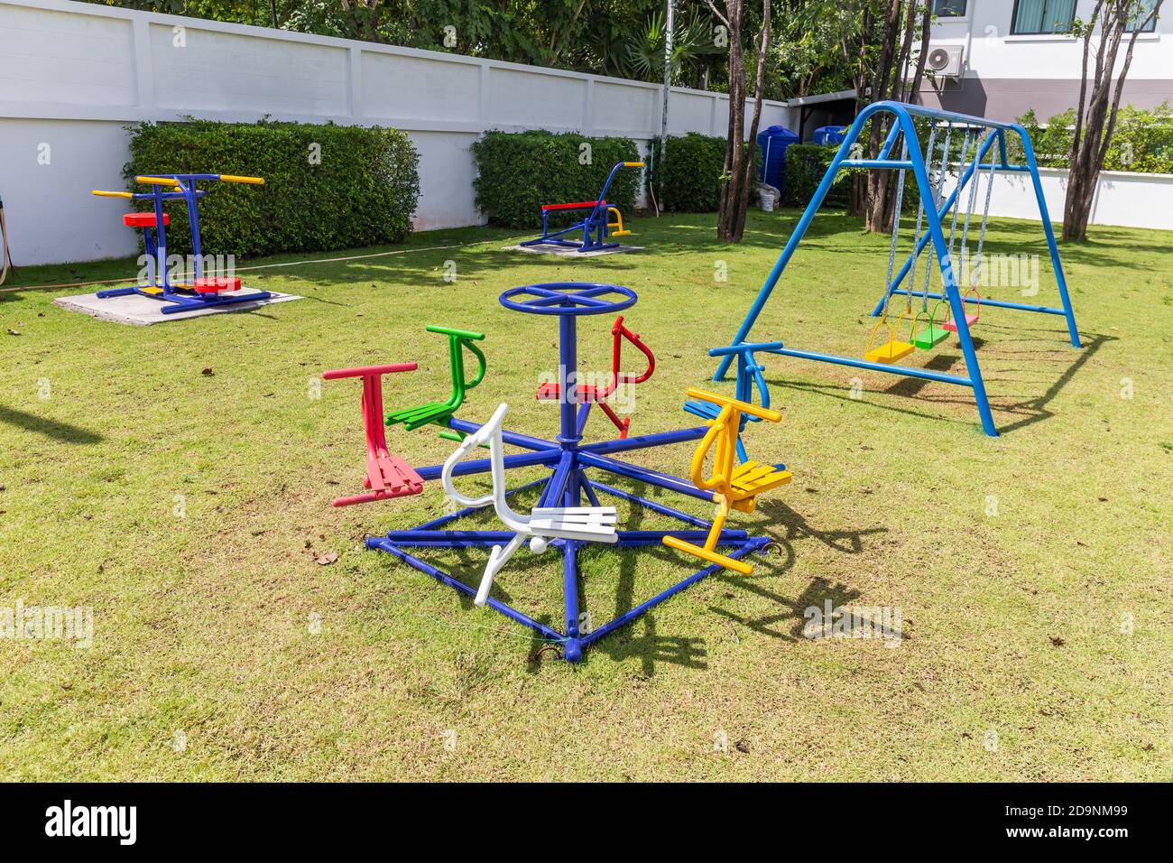 Colorful playground equipment and exercise at grass field outdoor public Stock Photo