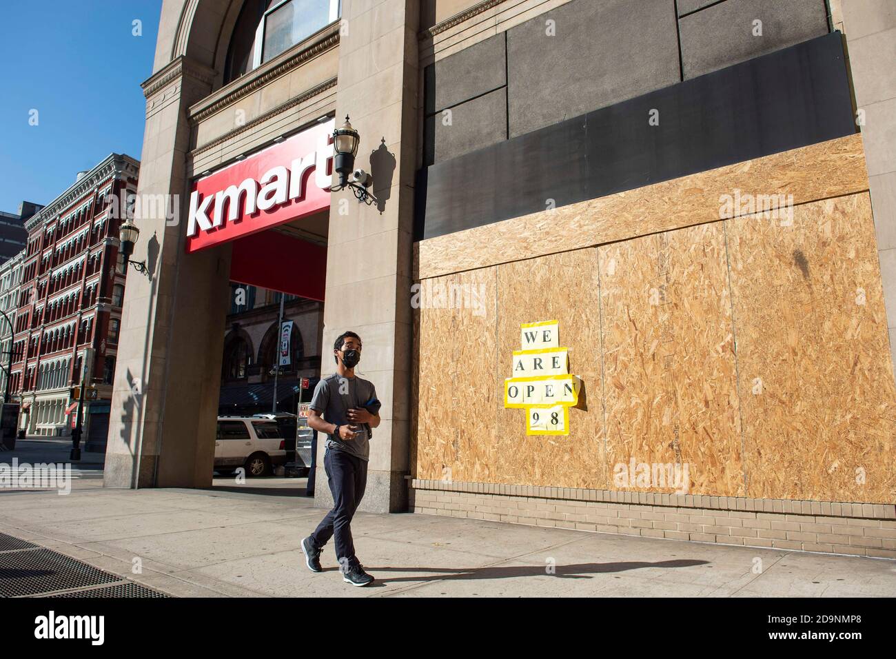 Manhattan, New York, USA. 06th Nov, 2020. A man wearing a PPE mask walks past a KMART that is boarded up in preparation for civil unrest due to the election on Broadway Ave in Manhattan, New York. Mandatory credit: Kostas Lymperopoulos/CSM/Alamy Live News Stock Photo
