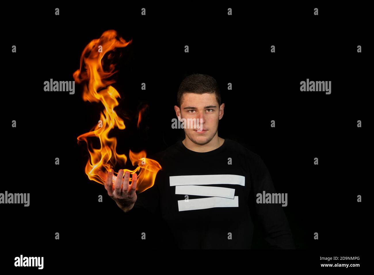 Guy holding flame in his hand. Stock Photo