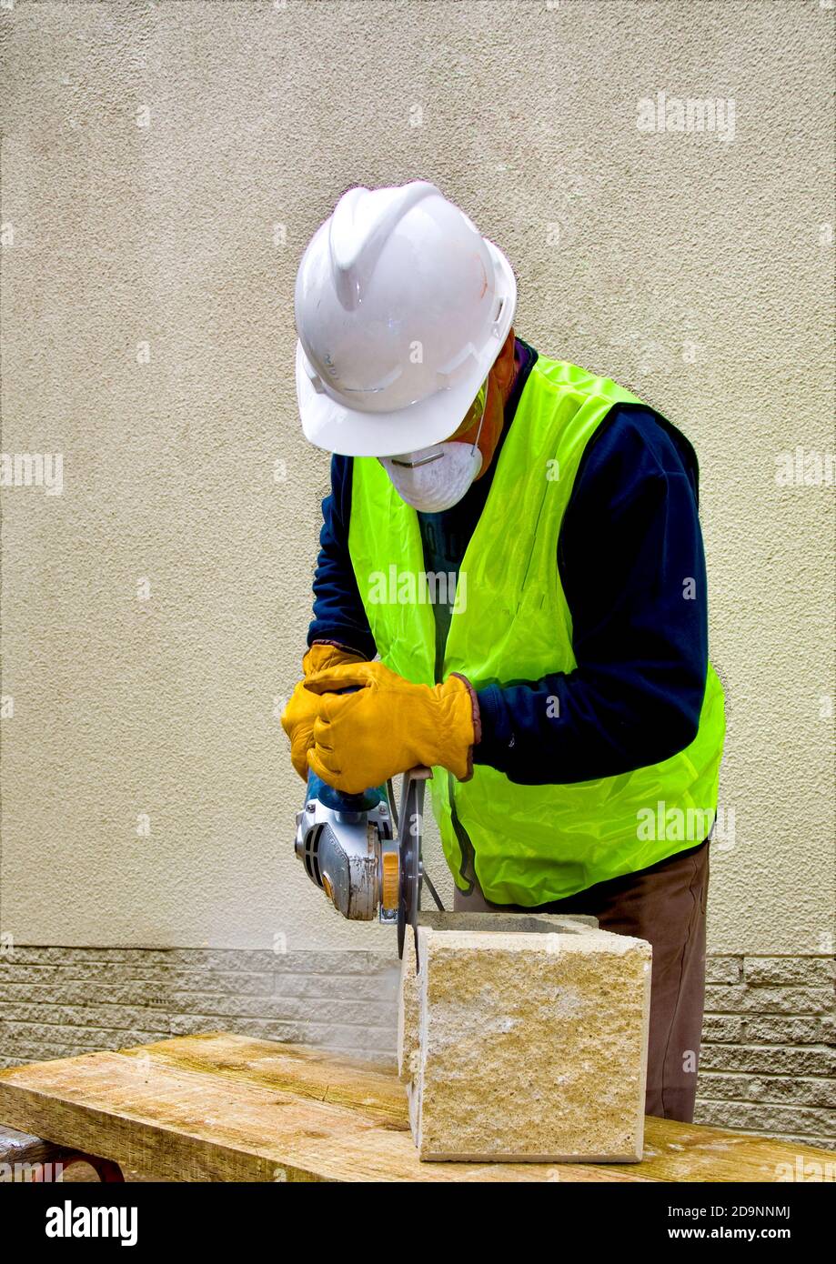 Australian building worker in safety gear using angle grinder in Canberra, the Australian national capital Stock Photo