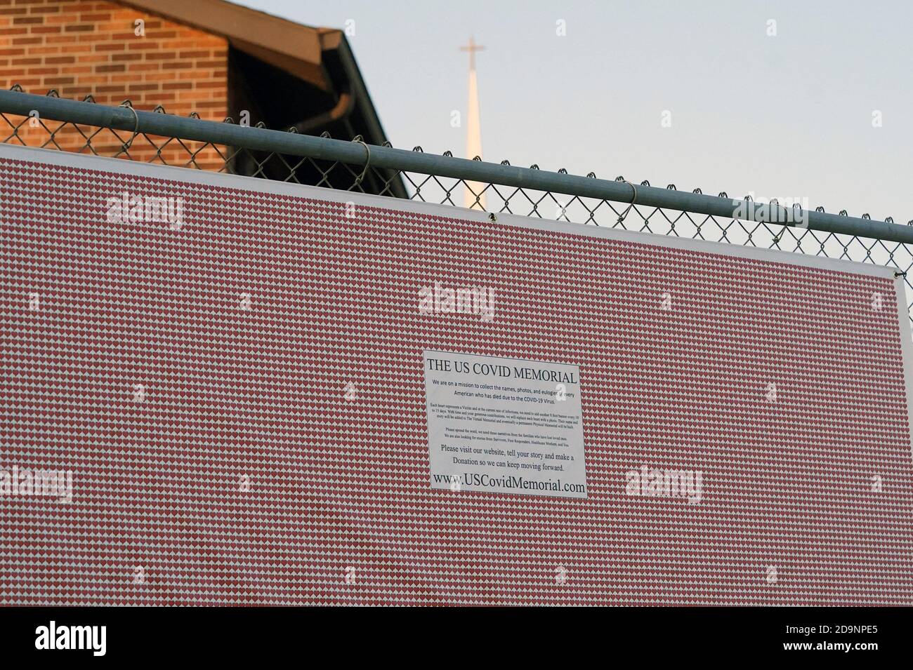 Valley Park, United States. 06th Nov, 2020. A panel of the U.S. Covid Memorial hangs on a fence at the Valley Park United Methodist Church in Valley Park, Missouri on Friday, November 6, 2020. With 5,000 deaths a week from the coronavirus, Todd Hulbert started collecting names and photos in July of those that have died. The memorial, made up of photos and 22 banners of hearts, will move to Springfield, Missouri and Kansas City, later in the month. Photo by Bill Greenblatt/UPI Credit: UPI/Alamy Live News Stock Photo