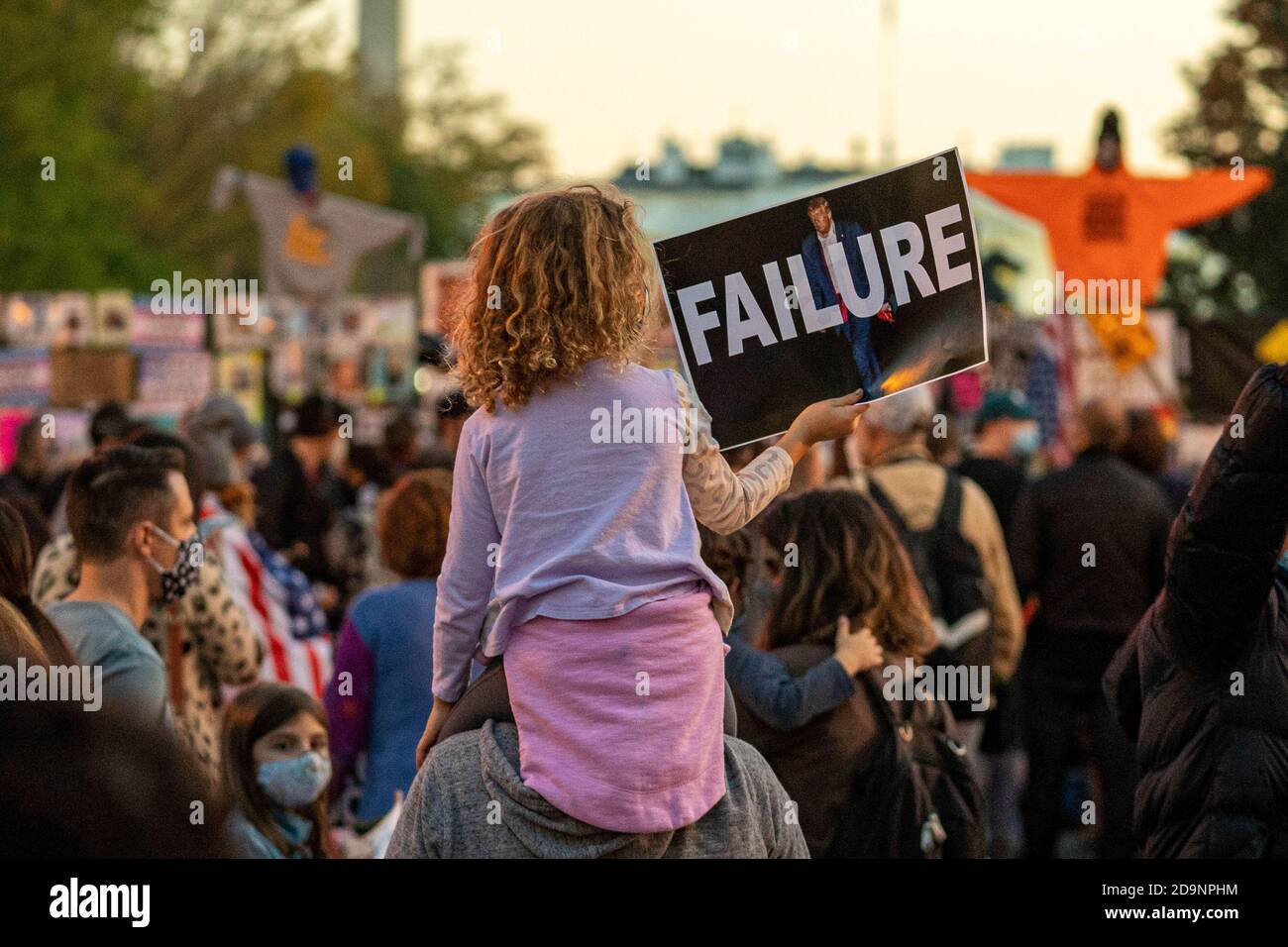 Washington, United States. 06th Nov, 2020. Mia, 7 yrs old, sits atop her father's back with a sign reading, 'Failure', as they and hundreds of others hang out at BLM Plaza near the White House in Washington, DC on Friday, November 6, 2020. Democratic Presidential Candidate Joe Biden and President Donald Trump are in a close race that is leaning to Biden in several states where the counting continues. Photo by Ken Cedeno/UPI Credit: UPI/Alamy Live News Stock Photo