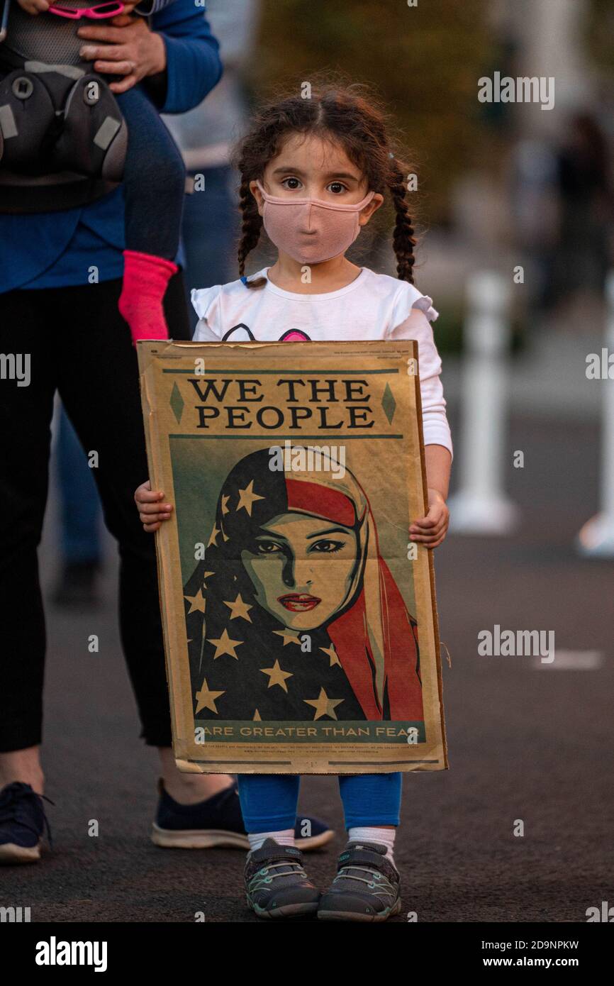 Washington, United States. 06th Nov, 2020. Leah Sanhi, 3.5 yrs old, holds a sign left over from the Women's March almost four years ago at the BLM Plaza near the White House in Washington, DC on Friday, November 6, 2020. Democratic Presidential Candidate Joe Biden and President Donald Trump are in a close race that is leaning to Biden in several states where the counting continues. Photo by Ken Cedeno/UPI Credit: UPI/Alamy Live News Stock Photo