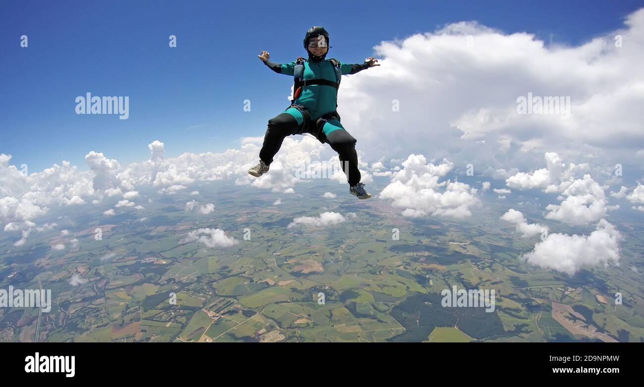 Skydiver woman falling in sitting control Stock Photo