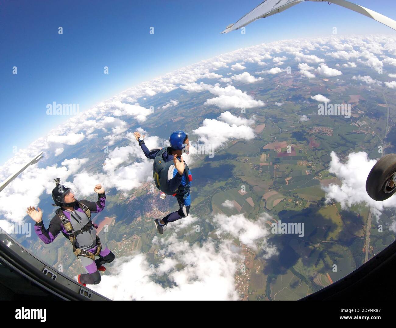 Skydivers jumping out of plane, inside view. Stock Photo