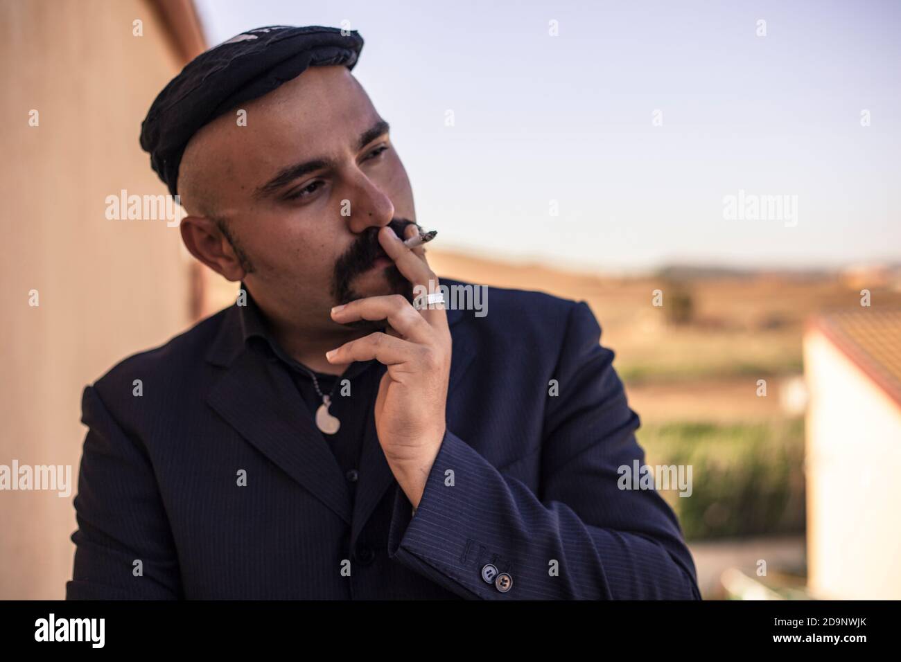 Godfather model symbol of Italian mafia businessman in elegant outdoor suit Stock Photo