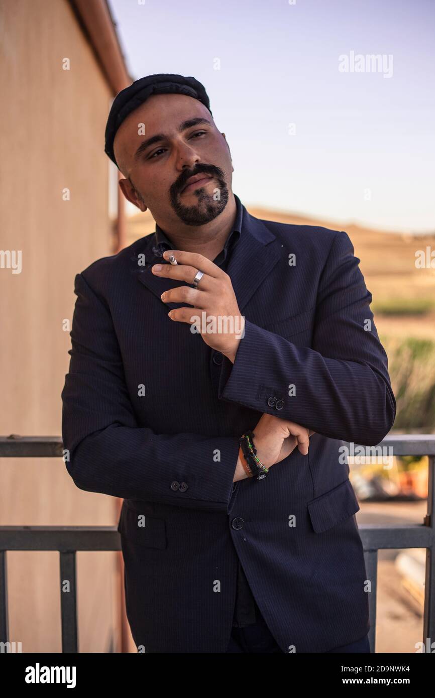 Godfather model symbol of Italian mafia businessman in elegant outdoor suit Stock Photo