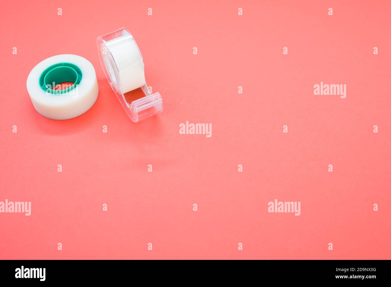 A top view closeup of a white duct tape and a tape dispenser isolated on a bright  pink background Stock Photo - Alamy