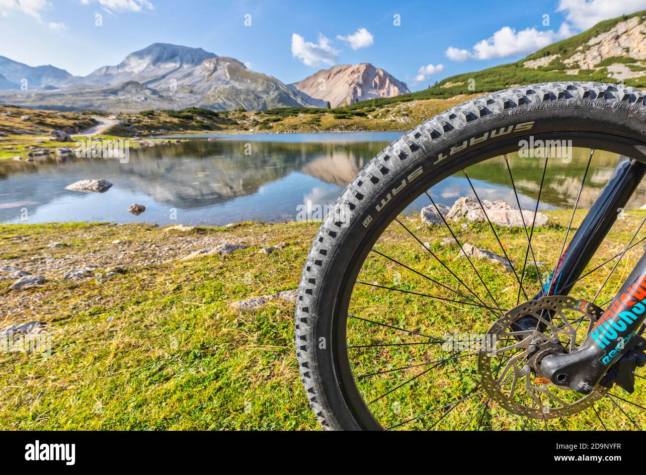 mtb bicycle tire and rim, Limo lake in the background, Dolomites of Fanes  Sennes Braies, San