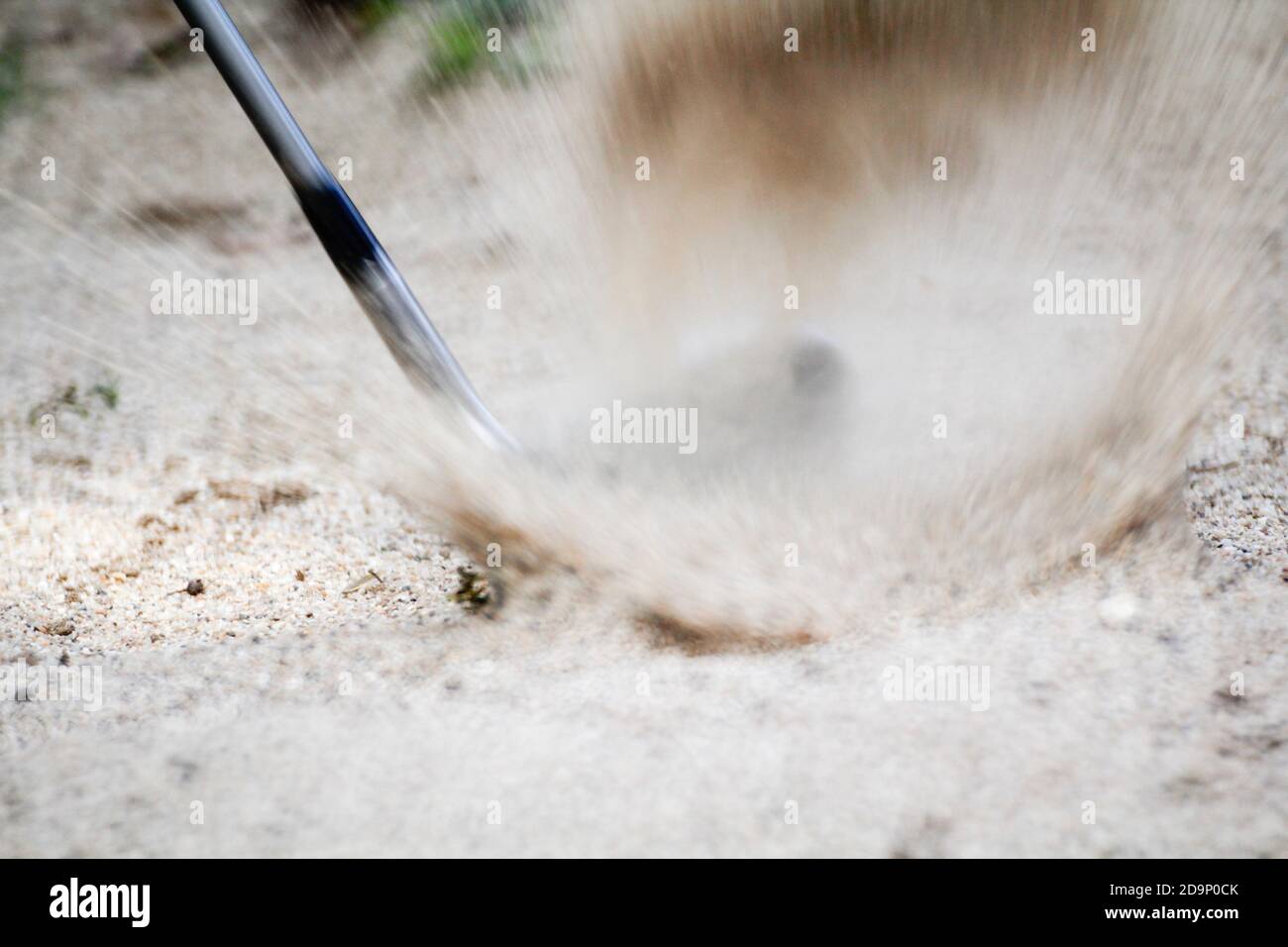 Golf sand wedge hitting in trap Stock Photo