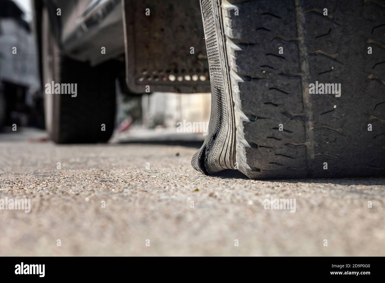 Flat tire car on side of street because expired tyre Stock Photo Alamy
