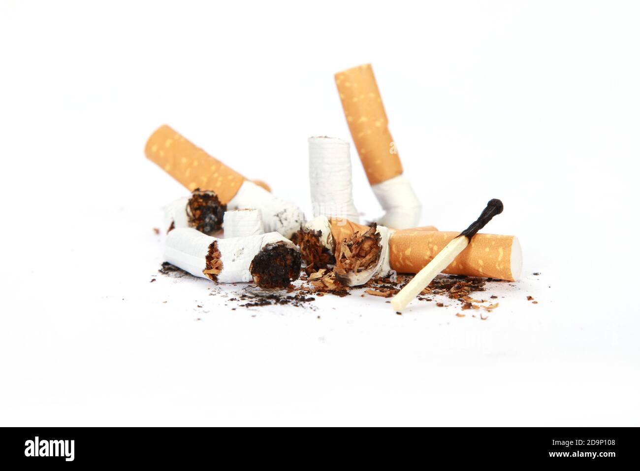 A pile of smoked old cigarettes and used matches isolated on a white  background Stock Photo