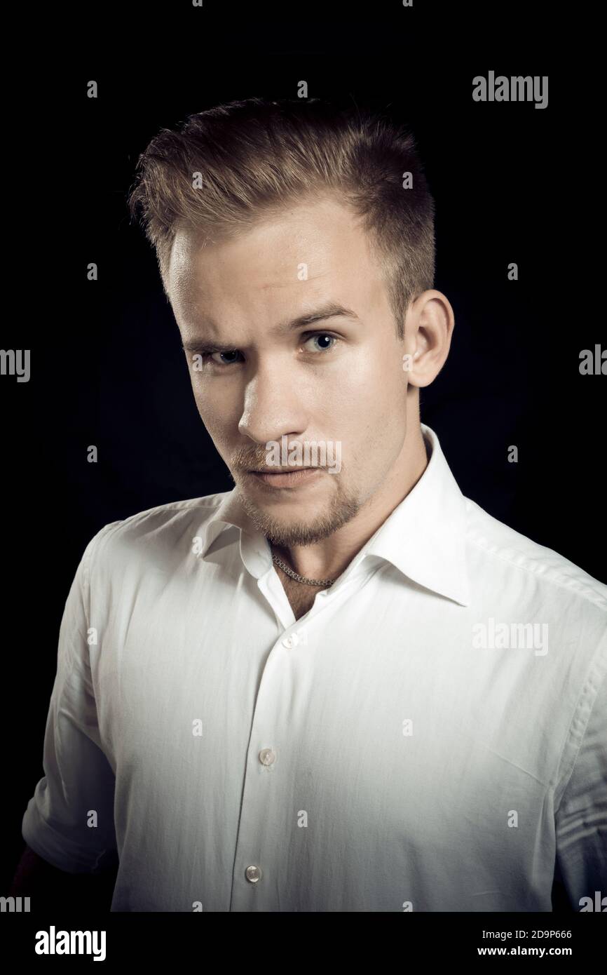 Young man dressed in white shirt studio emotional portrait Stock Photo ...