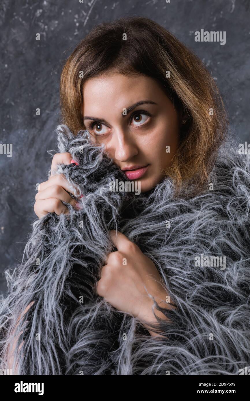 Pretty young woman dressed in fur coat studio portrait Stock Photo - Alamy
