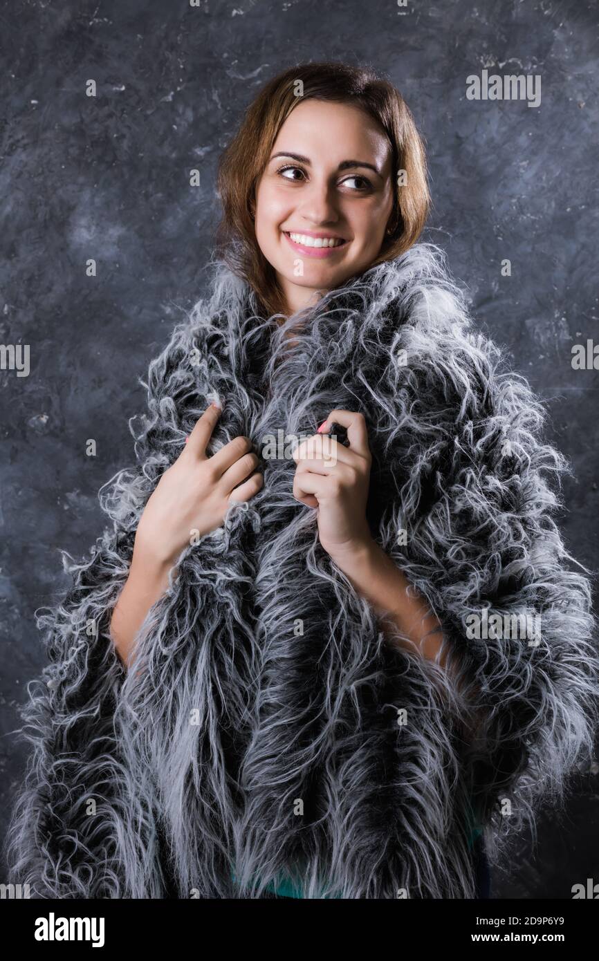 Pretty young woman dressed in fur coat studio portrait Stock Photo - Alamy
