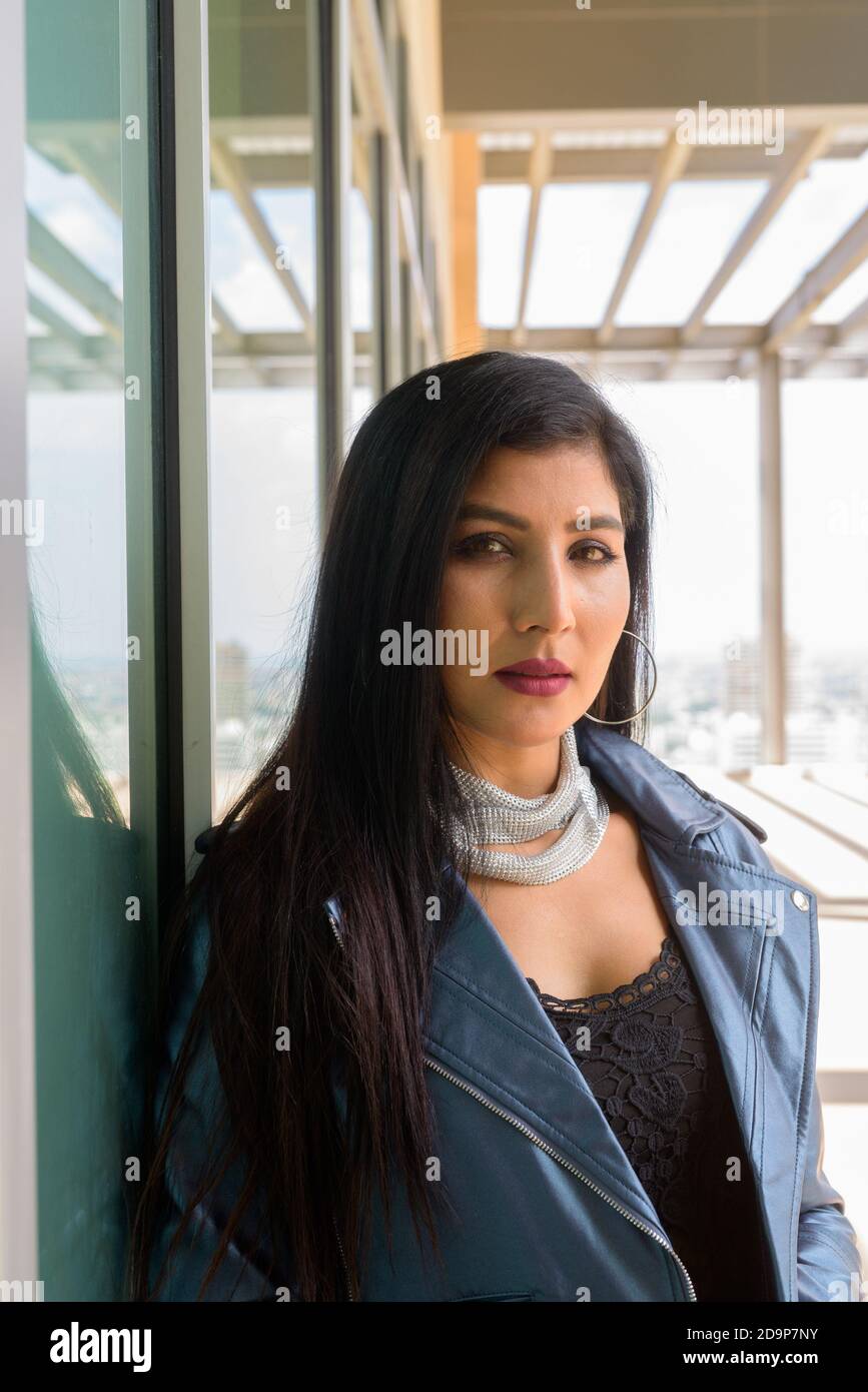Portrait of beautiful young woman looking at camera Stock Photo - Alamy