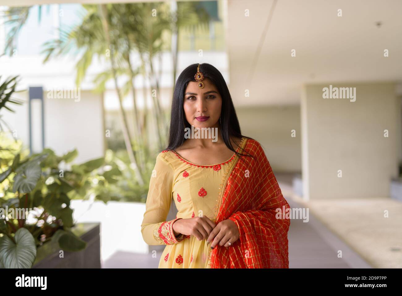 Portrait of beautiful young woman wearing traditional Indian dress ...