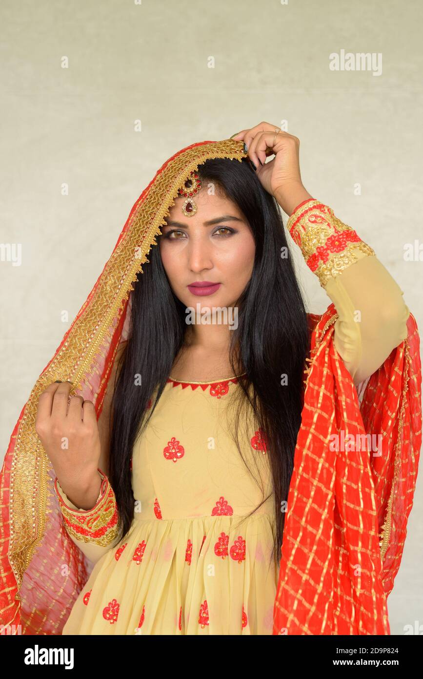 Portrait of beautiful young woman wearing traditional Indian dress ...