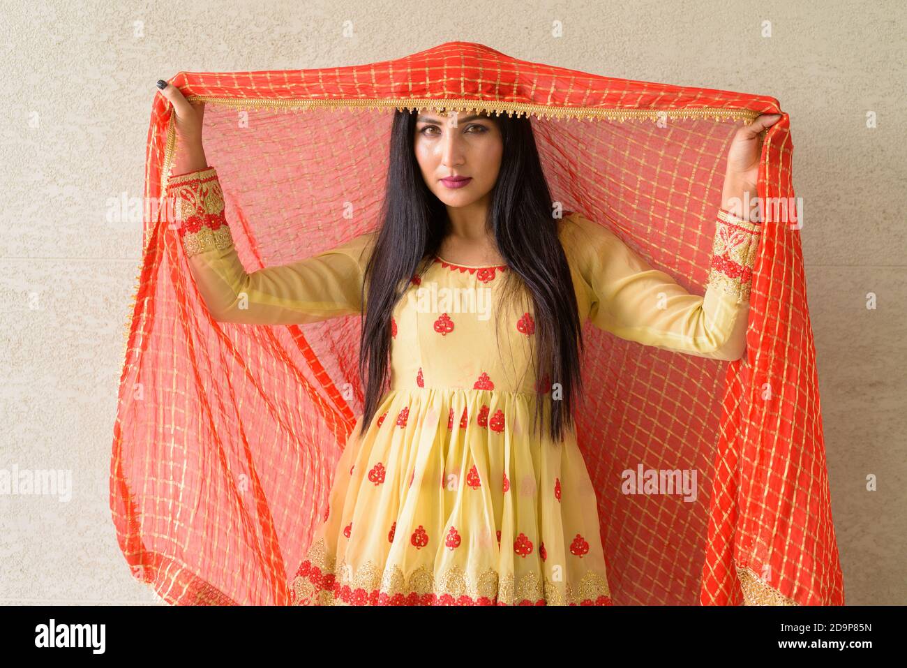 Portrait of beautiful young woman wearing traditional Indian dress ...