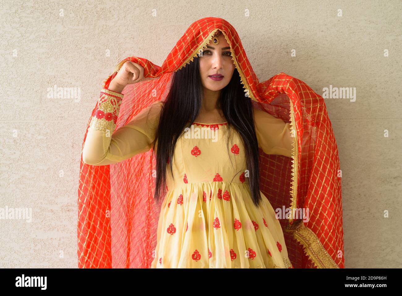 Portrait of beautiful young woman wearing traditional Indian dress ...