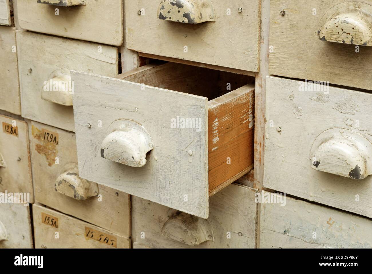 Backgrounds and textures: old wooden cabinet with drawers, one drawer opened, close-up shot Stock Photo