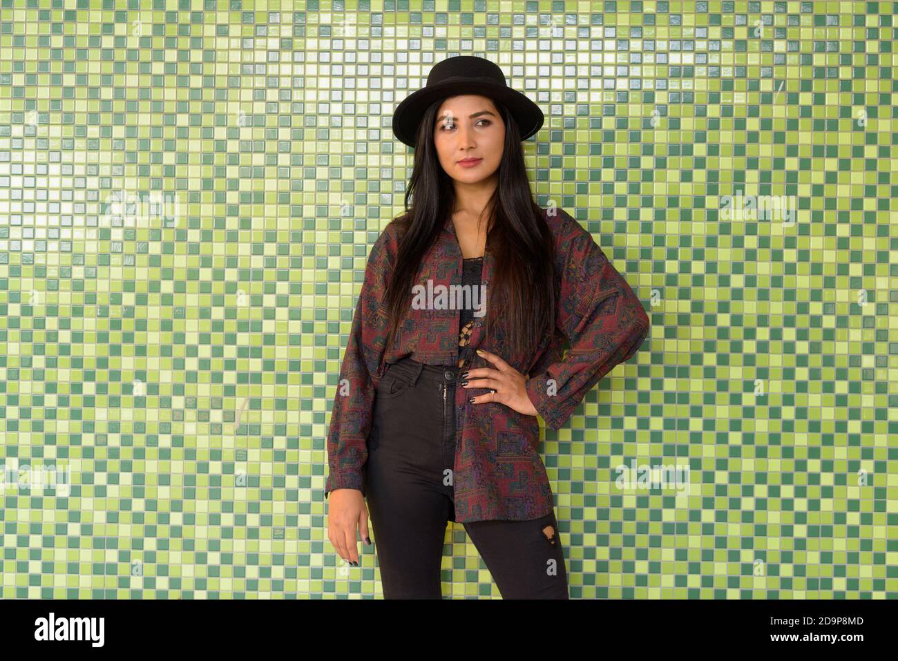 Portrait of beautiful young woman against colorful wall Stock Photo - Alamy