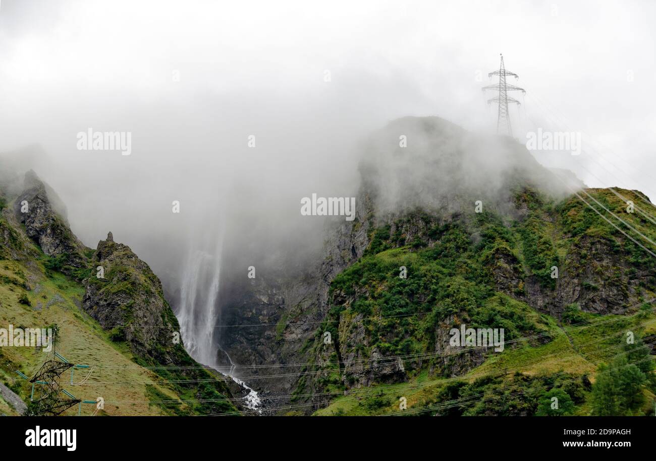 mountains of the Felber Tauern in the national park 'High Tauern' with mist, water falls and electric power transmission line, Salzburg, Austria Stock Photo