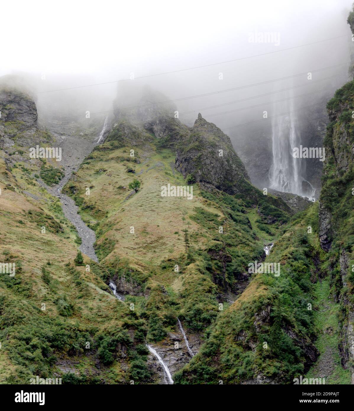 mountains of the Felber Tauern in the national park 'High Tauern' with mist water falls and electric power transmission line, Salzburg, Austria Stock Photo